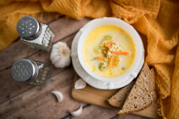broccoli cheese soup served with toasted bread in a bowl