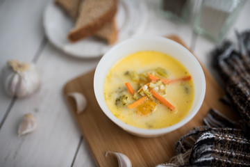 broccoli cheese soup served with toasted bread in a bowl