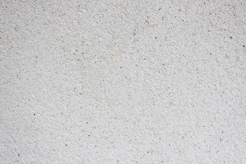 Cement wall mixed with grains of sand as a background