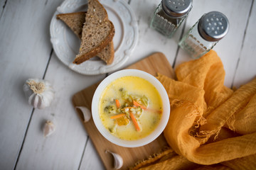 broccoli cheese soup served with toasted bread in a bowl
