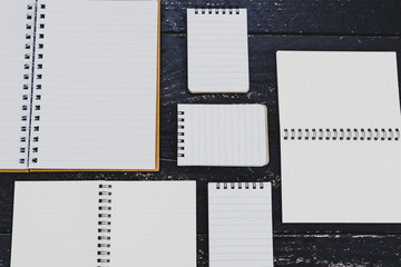 starting a new project conceptual still-life, group of different notepad and notebooks opened up on desk with blank pages