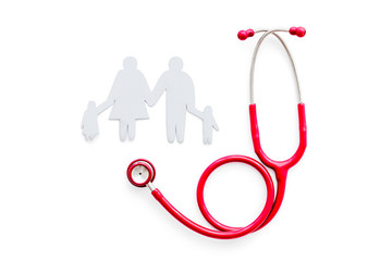 Family health care concept. Heart icon and stethoscope on white background top view