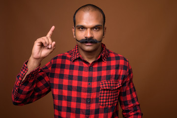Obraz premium Portrait of Indian hipster man with mustache