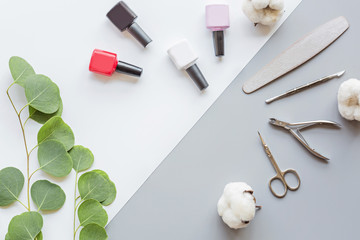 Stylish trendy manicure accessories with gel nail polishes, scissors, cuticle pusher, cotton and...