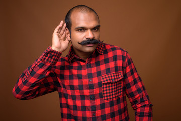 Obraz premium Portrait of Indian hipster man with mustache