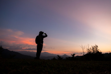 The traveler using the phone with sunset background