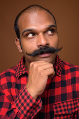 Face of Indian hipster man with mustache