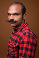 Face of Indian hipster man with mustache