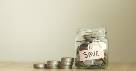 Coins in glass jar for money saving financial concept