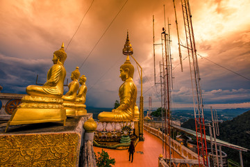 Fototapeta premium Wat Tham Seua Krabi-Krabi: 20 October 2019, atmosphere of a large Buddha statue on a high mountain, with tourists always coming to make merit, Tiger Cave Mountain Temple, Krabi area Noi, Thailand