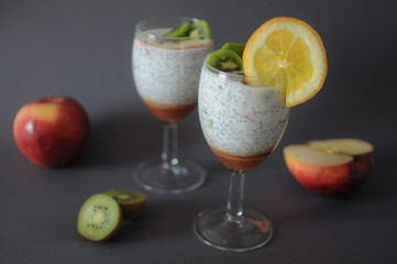 Healthy chia pudding in a glass with fresh fruits and honey