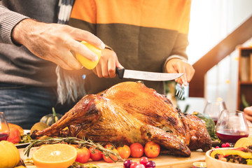 Thanksgiving Celebration Tradition Family Dinner Concept.family having holiday dinner and cutting turkey.Young black adult woman and her daughter happy..