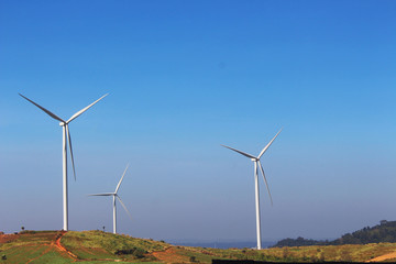 Wind mill turbine on the top of mountain in blue sky, the natural generator energy. From petchaboon