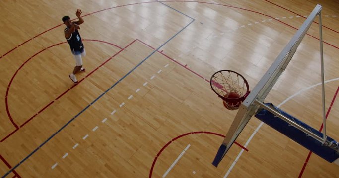 OVERHEAD HIGH ANGLE JIB SHOT African American Black College Male Basketball Player Practicing Shots Alone On The Indoor Court. 4K UHD 50 FPS SLOW MOTION RAW Graded Footage