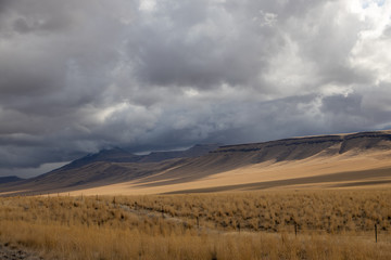 Fototapeta na wymiar Clouds and Mesas in the Nevada Desert