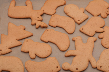 Fresh baked homemade Chritstmas gingerbread cookie on a baking tray.