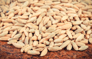 Heap of rye grains on old background structure