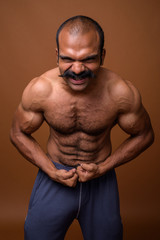 Portrait of muscular Indian man with mustache shirtless