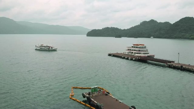 Drone circle around the ferry pier on the lake