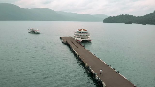 Drone circle around the ferry pier on the lake