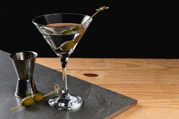 Fototapeta Drink Dry Martini with Green Olives on Stone Background. obraz