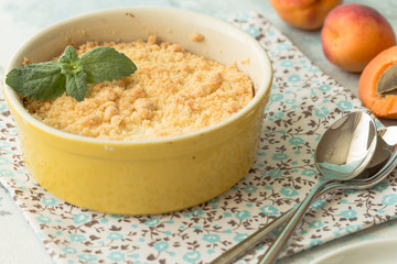 Crumble apricot pie on white table, morning dessert