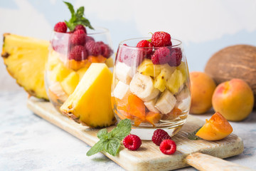 Fresh healthy fruit salad. Selective focus. Natural eating. Fruit salad on white background - diet, healthy breakfast. Healthy food dinner table. Gourmet food. Copy space. Tropical fruit.
