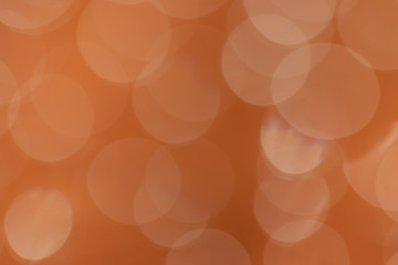 Abstract bokeh circles background on orange color background