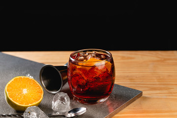 Boulevardier cocktail on stone background in gray color.