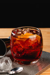 Boulevardier cocktail on stone background in gray color.