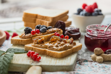 Toast bread with homemade strawberry jam and peanut butter. Homemade toast bread with jam and...