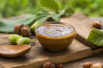 Homemade chocolate with hazelnut in a glass bowl with nuts, cocoa powder. The concept of...