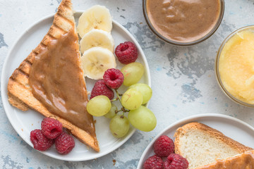 Homemade toast bread with jam and variety peanut almond  butter on wood table for breakfast. Delicious toast bread ready to served.