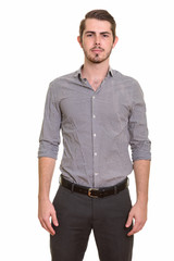 Fototapeta premium Portrait of young handsome bearded businessman looking at camera