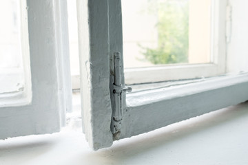 An open window in the entrance. White frame. Repair in the summer in an apartment building