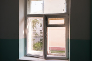 Window in the stairwell. White wooden frame inside the building. After repair in an apartment building