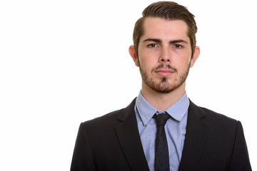 Portrait of young handsome bearded businessman in suit