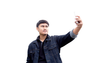 portrait of asian man in blue jean jecket are taking photo by smartphone on white background. Asian man is taking a selfie with a mobile phone.