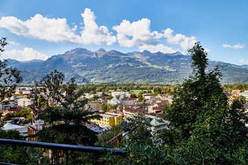 Obraz premium Mountains and a view from the height of the valley with houses at the bottom of a Sunny summer day