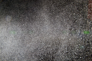 Abstract dust explosion and flash with illumination on a black background