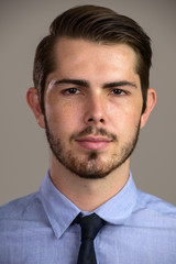Face of young handsome bearded businessman looking at camera
