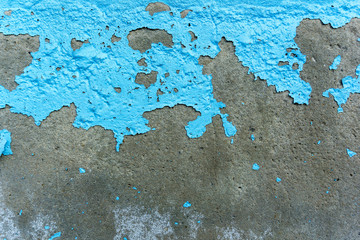 Peeling of paint on the surface of old concrete walls outside the building, Blue cracked paint damaged on concrete wall 