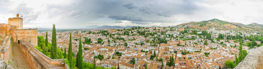 Fototapeta na wymiar Alhambra. Panoramic views of the mountains and the old city from the observation deck of Alcazaba. Granada, Andalusia, Spain