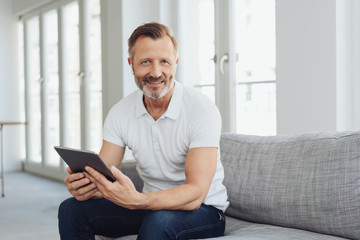 Casual middle-aged man relaxing at home - Powered by Adobe