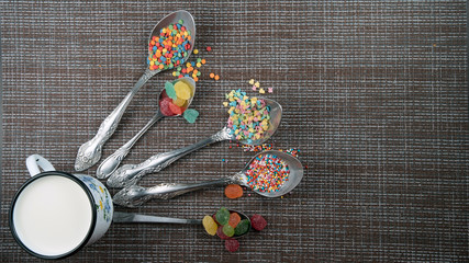 spoons, sweets, and a mug with milk flatlay