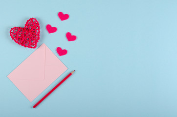 Red heart composition on blue background. Flat lay.