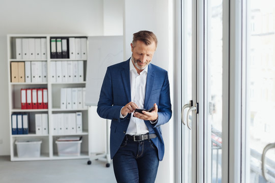 Confident businessman using a mobile in the office
