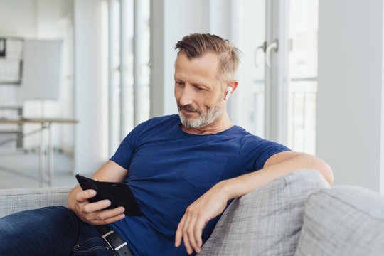 Relaxed casual man reading a text message