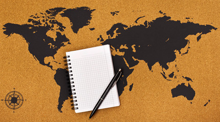 Pen and notepad on a map. Top view. Travel and planning concept.
