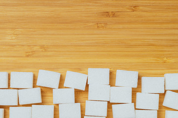 refined sugar on a wooden background at the bottom of the image, moc ap, space for text at the top, tinted image, selective focus